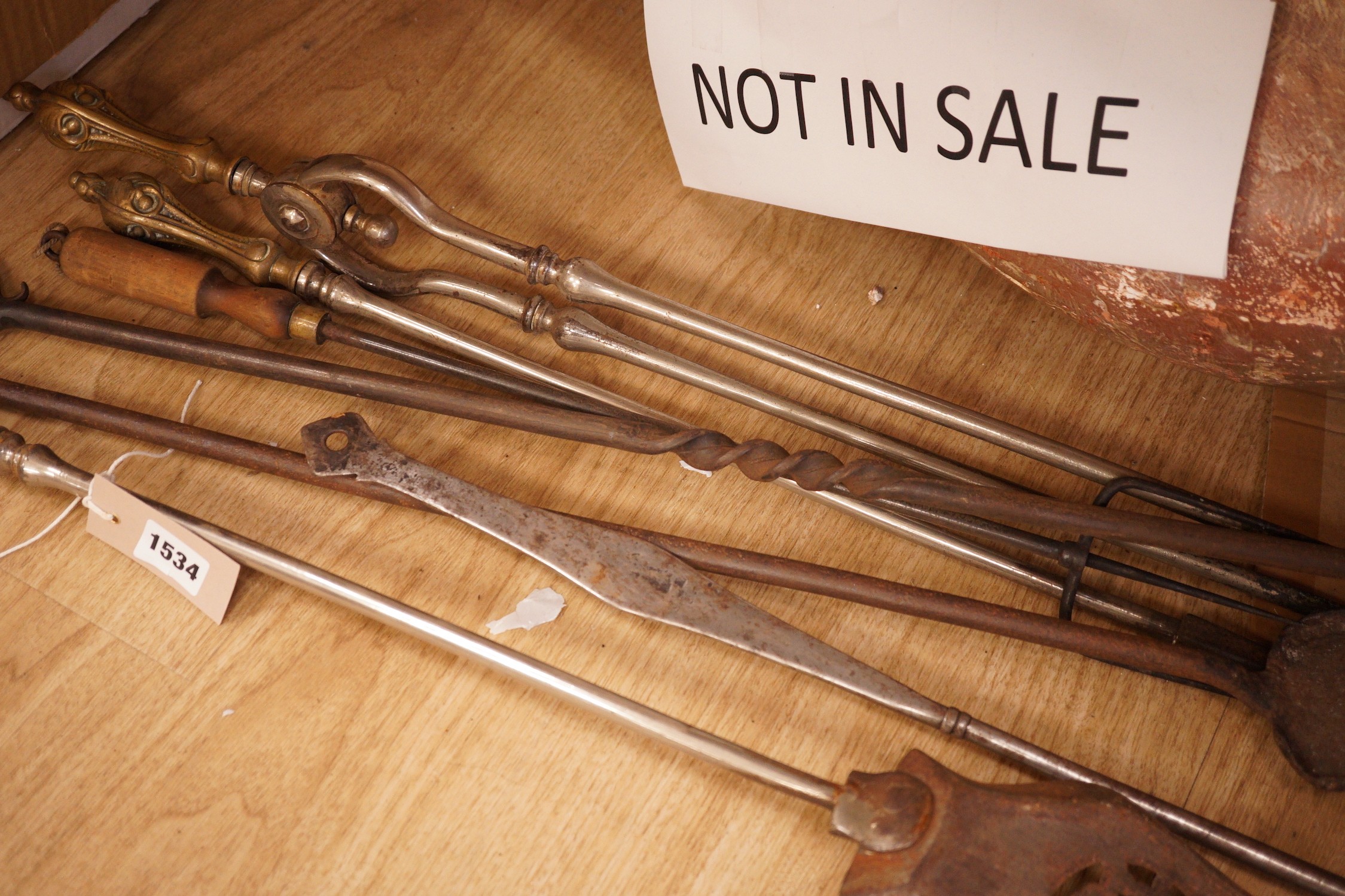 A set of three 19th century steel and brass fire irons and others
